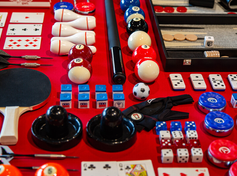 table full of small gifts, dice, billiard balls, gloves